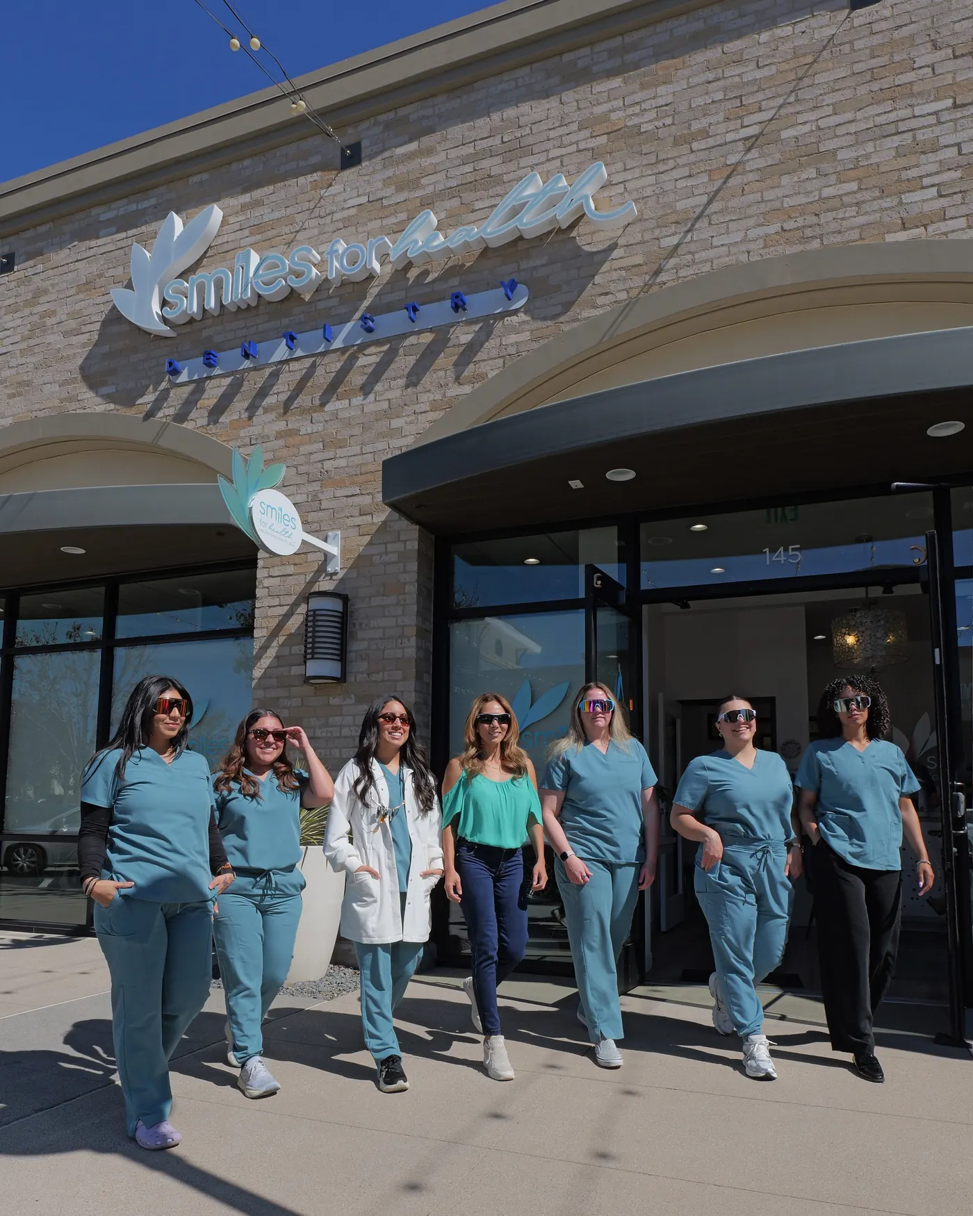 The Smiles for Health team walking out of the Gateway Road office in Carlsbad